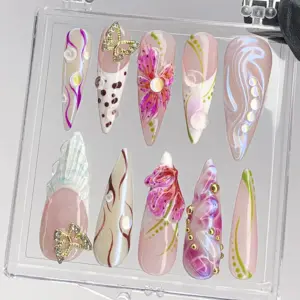 3D butterfly floral stiletto press on nails in pink and purple with aurora shimmer and gold charm, displayed in clear nail box