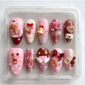 3D Christmas press on nails with gingerbread bear, reindeer, jingle bell, candy cane and glitter charms in pink and brown