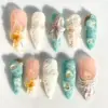 3D conch shell press on nails in teal and peach with sculpted sea foam coral texture starfish gold foil and hibiscus bloom