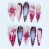 3D Floral Press On Nails - Dark Botanical Bloom Fake Nails | ST34 2 Dark botanical 3D floral press on nails with hand-sculpted magenta blooms, white 3D flowers, purple swirl calligraphy, gold shell charms, and deep burgundy gradient