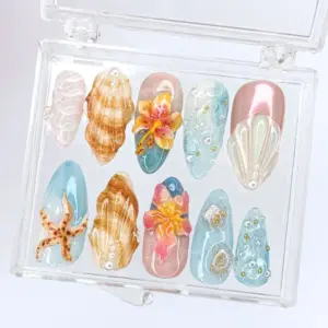 3D hibiscus conch shell press on nails in rose gold aqua blue peach and amber with starfish ocean swirls and gold bead accents displayed in clear acrylic box