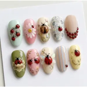 3D ladybug press on nails with rhinestone clusters, opal wings, hand-painted flowers, floral print and pastel bases in mint, pink, olive and yellow for spring