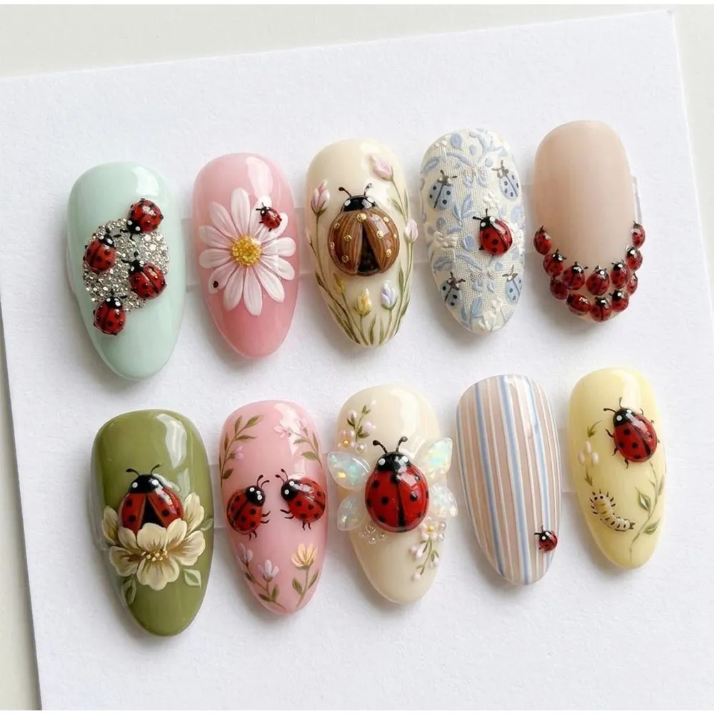 3D ladybug press on nails with rhinestone clusters, opal wings, hand-painted flowers, floral print and pastel bases in mint, pink, olive and yellow for spring