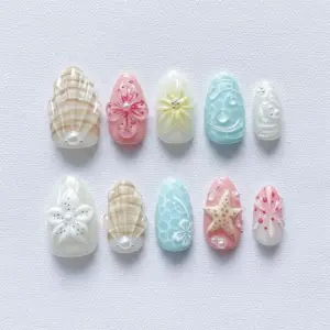 3D shell starfish press on nails in pastel white pink beige and blue with floral blooms pearl accents and ocean bubble textures