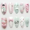 Pastel pink and mint green 3D Christmas press on nails with snowman, reindeer, Santa gift sack, pink bow, candy cane, poinsettia flowers, snowy village scene and gingerbread man charms