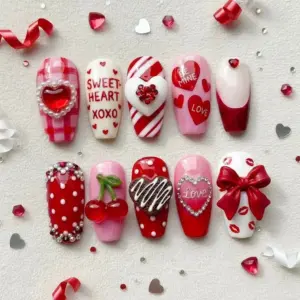 Luxury 3D Valentine's Day press on nails with sweetheart XOXO, cherry, chocolate, bow, rhinestone heart and candy cane designs in red and pink
