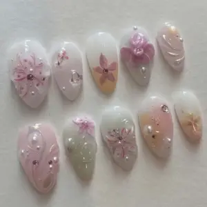 Sheer milky 3D floral press on nails with pearl accents, pink hand-painted florals, rhinestones and jelly glass finish for spring bridal