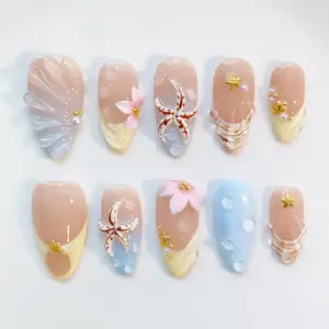 Nude beach press on nails with 3D realistic brown starfish charm, soft pink 3D floral bloom with gold bead, sculptured shell fan relief in blue-nude ombré and champagne tones, bubble gel water droplet texture on powder blue base, gold mini starfish charms, and pearl bead accents on summer fake nails