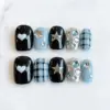 Blue Black Y2K Press On Nails - Star Heart Plaid Fake Nails | ST39 8 Blue black Y2K press on nails with white heart, silver star charm, plaid pattern, crystal gem accents, and silver chrome nail on marble background