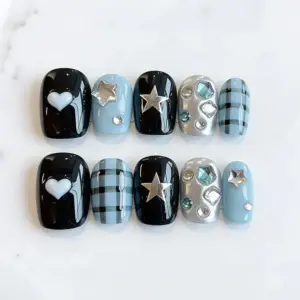 Blue black Y2K press on nails with white heart, silver star charm, plaid pattern, crystal gem accents, and silver chrome nail on marble background