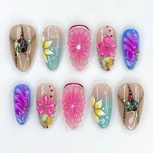 Boho summer press on nails with multicolor gemstone gold star charm on nude, hand-painted yellow flower on mint-teal with white scroll art, 3D translucent pink citrus slice with white starburst, fuchsia floral bloom with rhinestone dots, and purple-blue aurora butterfly wing nail with silver shimmer on summer fake nails