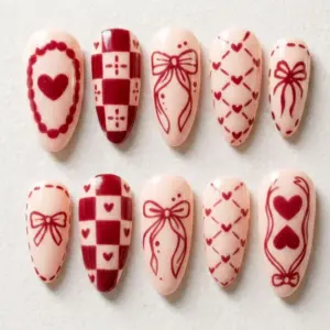 Cream and burgundy red coquette Valentine's Day press on nails with hand-drawn bow, heart cameo, checker pattern and lattice heart designs