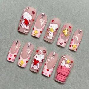 Blush pink Valentine's Day cartoon press on nails with beagle dog hugging heart, yellow bird characters, paw prints, sparkle stars and rhinestone charms