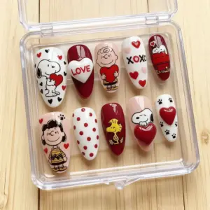 Cute Valentine's Day cartoon press on nails with beagle dog, boy, girl, yellow bird characters, XOXO, hearts, paw prints and 3D heart gem in a clear nail box