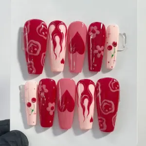 Y2K red and pink press on nails with cherry, flame, heart, flower and grunge art designs for Valentine's Day
