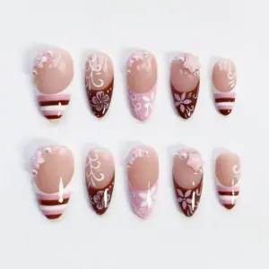Chocolate brown floral French press on nails with pearl beads, pink star charm, and hand-painted white flower details