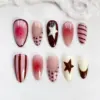 Chocolate strawberry press on nails with white star, polka dots, pink stripes, aura gradient, and chocolate French tip details