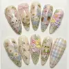 Cottagecore press on nails with hand-painted white bunny, butterflies, bees, mushrooms, forget-me-nots, 3D sculpted flowers, frog on mushroom, lace bow and pastel gingham on warm cream bases