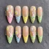 Easter French tip press on nails with 3D white bunnies, daisies, polka dots and pastel pink blue yellow green tips on sheer base