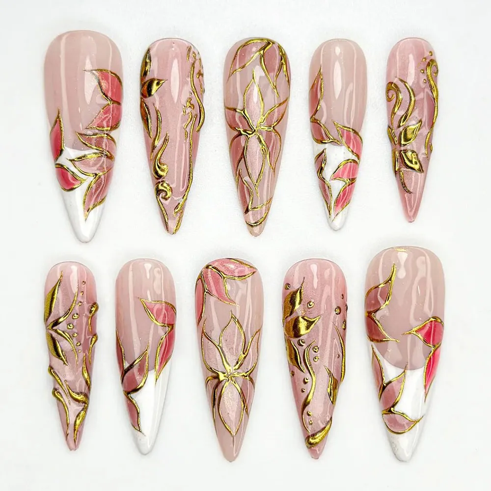 Long stiletto press on nails with gold foil lotus design on blush pink base and white french tips