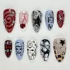 Grunge Y2K press on nails set with gothic doodles, cherry, silver star, plaid, leopard print, and rhinestone details