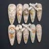Luxury vintage Easter press on nails with 3D bunnies, gold filigree, ribbon bows, roses and chick basket on champagne and sage bases