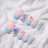 Ocean animal press on nails in blush pink and sky blue with dolphin turtle starfish and shell details