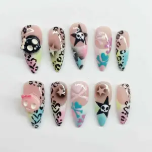 Pastel goth Y2K press on nails with multicolor leopard print, 3D skull charms, star motifs, skull crossbones, and airbrushed gradient details