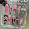 Pink Black Y2K Press On Nails - Bow Star Heart Fake Nails | ST37 9 Pink black Y2K press on nails in clear box with rhinestone bow, star chain charm, corset lace design, crystal heart, zebra print, honeycomb mesh, and glitter star details
