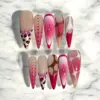 Pink leopard print press on nails with ombre gradient rhinestone stars and abstract swirl accents