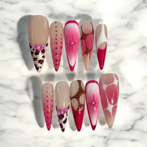 Pink leopard print press on nails with ombre gradient rhinestone stars and abstract swirl accents