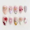 Bold summer press on nails with 3D pink floral blooms on zebra stripe and lavender shell base, glossy red cherry charm, gold starfish, blue bubble gel droplet nail, red flower on leopard print, starburst line art, iridescent petal flower on tiger stripe yellow, and translucent shell fan with pink dot accents on summer fake nails