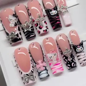 Sanrio Y2K press on nails set with 3D kitty and gothic cat charms, rhinestone star cross, silver bow, pink cross charm, zebra and leopard print details