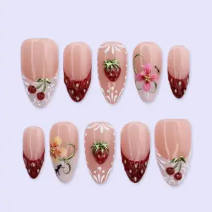 Strawberry French press on nails with 3D strawberry and cherry charms, white lace dot details, pink hibiscus flower, fairy silhouette, and deep red French tips