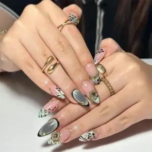 Wild cat stiletto press on nails worn on hands with gold rings, featuring zebra, leopard, cat-eye and 3D gold flower charm details