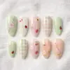 Cottagecore press on nails with 3D ladybugs, honeybees, strawberries, daisies, cherry blossoms and gingham in sage green, pink and peach for spring