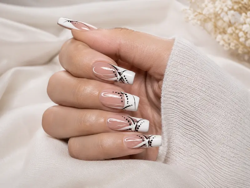 The 90s French manicure is typically more graphic than a micro French design, with a wider white section, a pink-beige base, and a square or softly squared shape